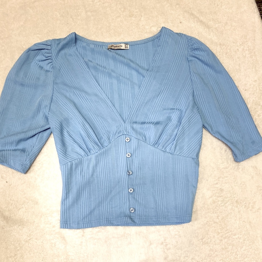 Size small, light blue, deep plunge v neck top